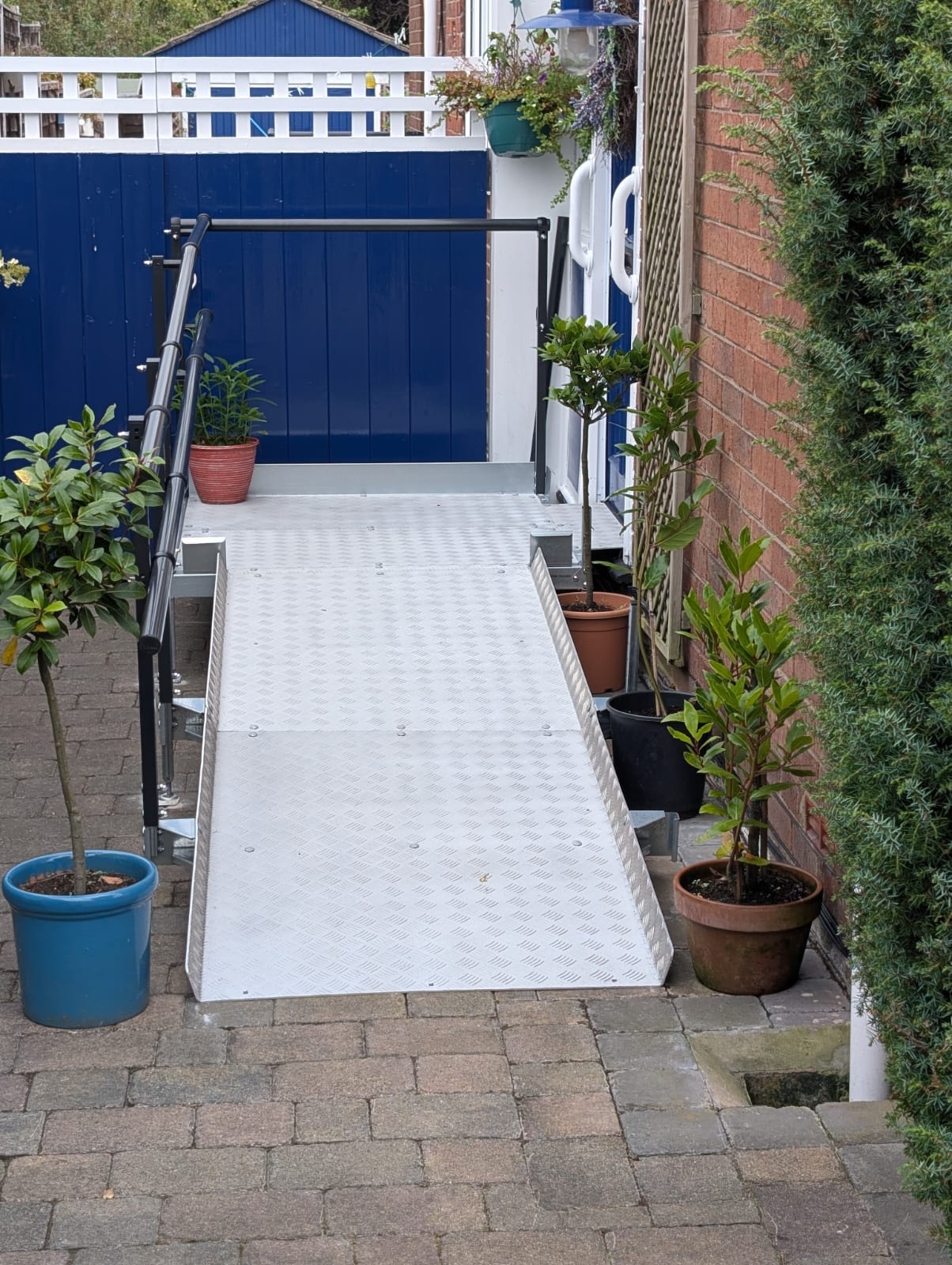 Side view of completed ramp showing handrail and surface detail