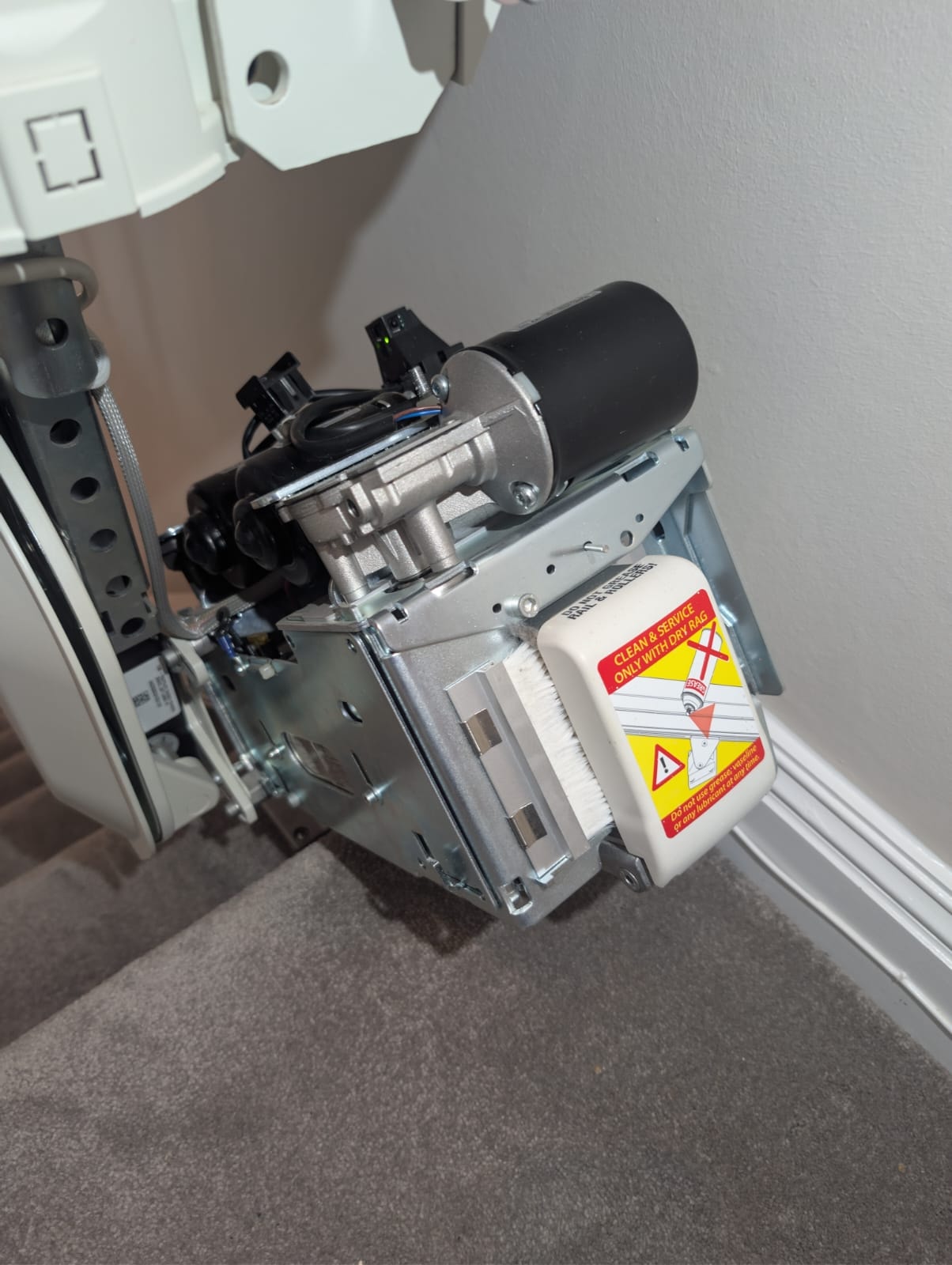 Internal view of Handicare 1100 drive unit with multiple motors and wiring visible
