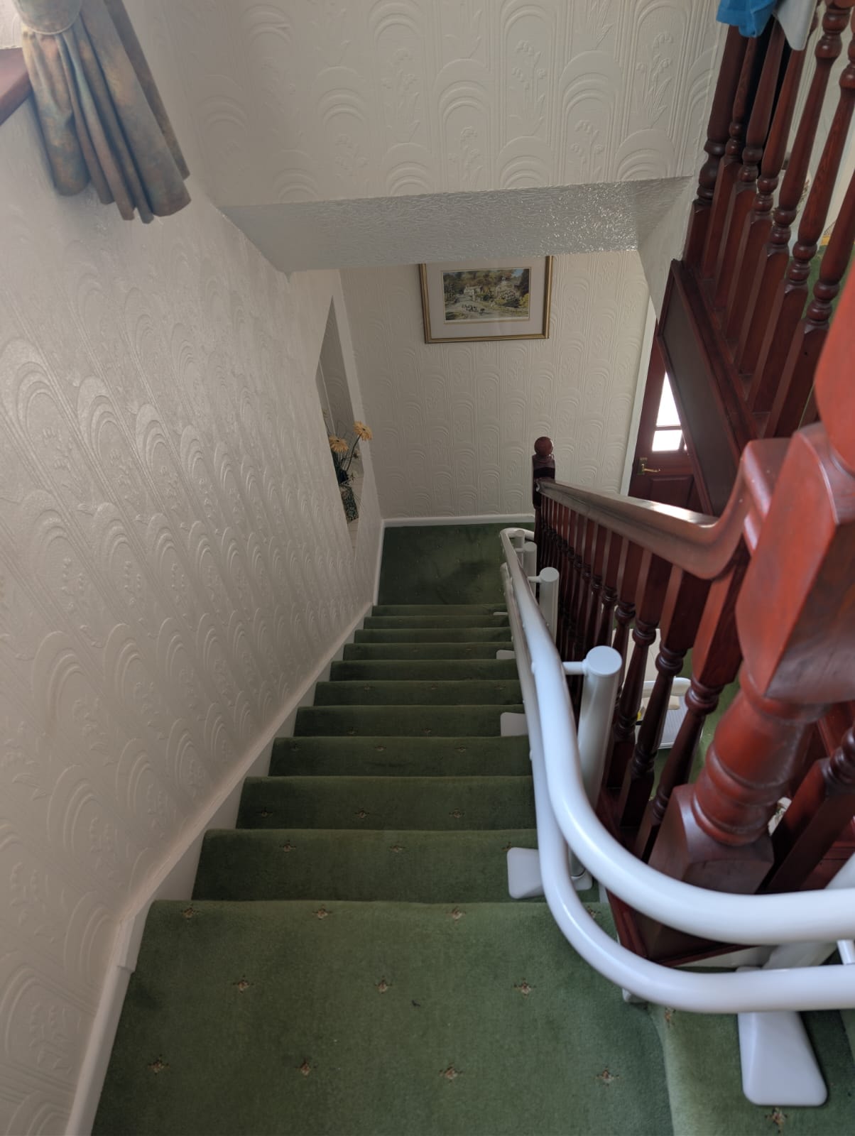 Handicare 4000 180° wrap-around curved stairlift installed in Wigan