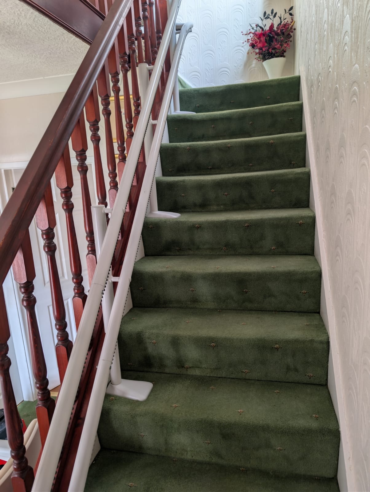 View up the stairs showing the full Handicare 4000 curved stairlift installation